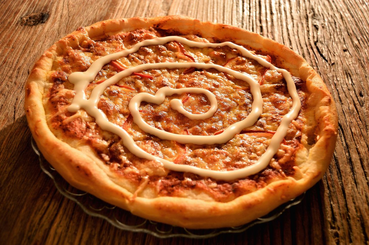 Yummy pizza with rich cheese and creamy sauce, perfect for a delightful meal.